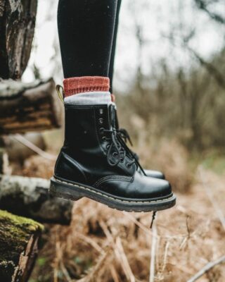 Eine Frau ist in der Natur trägt Schwarze Schnürstiefel